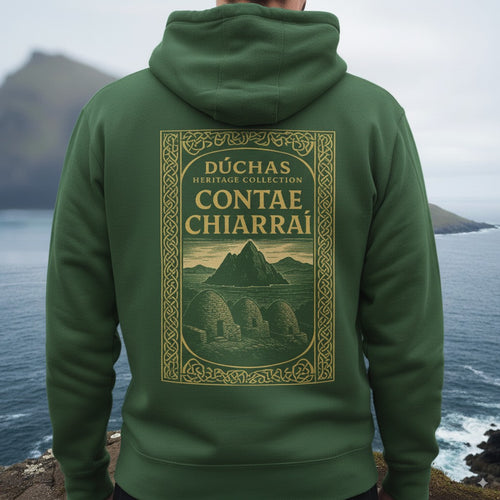 Green hoodie with 'D´chas Heritage Collection Contae Chiarrai' design on the back, worn by a person overlooking a scenic coastal view.