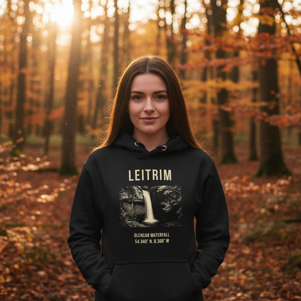 Person wearing a black hoodie with 'LEITRIM' text in an autumn forest