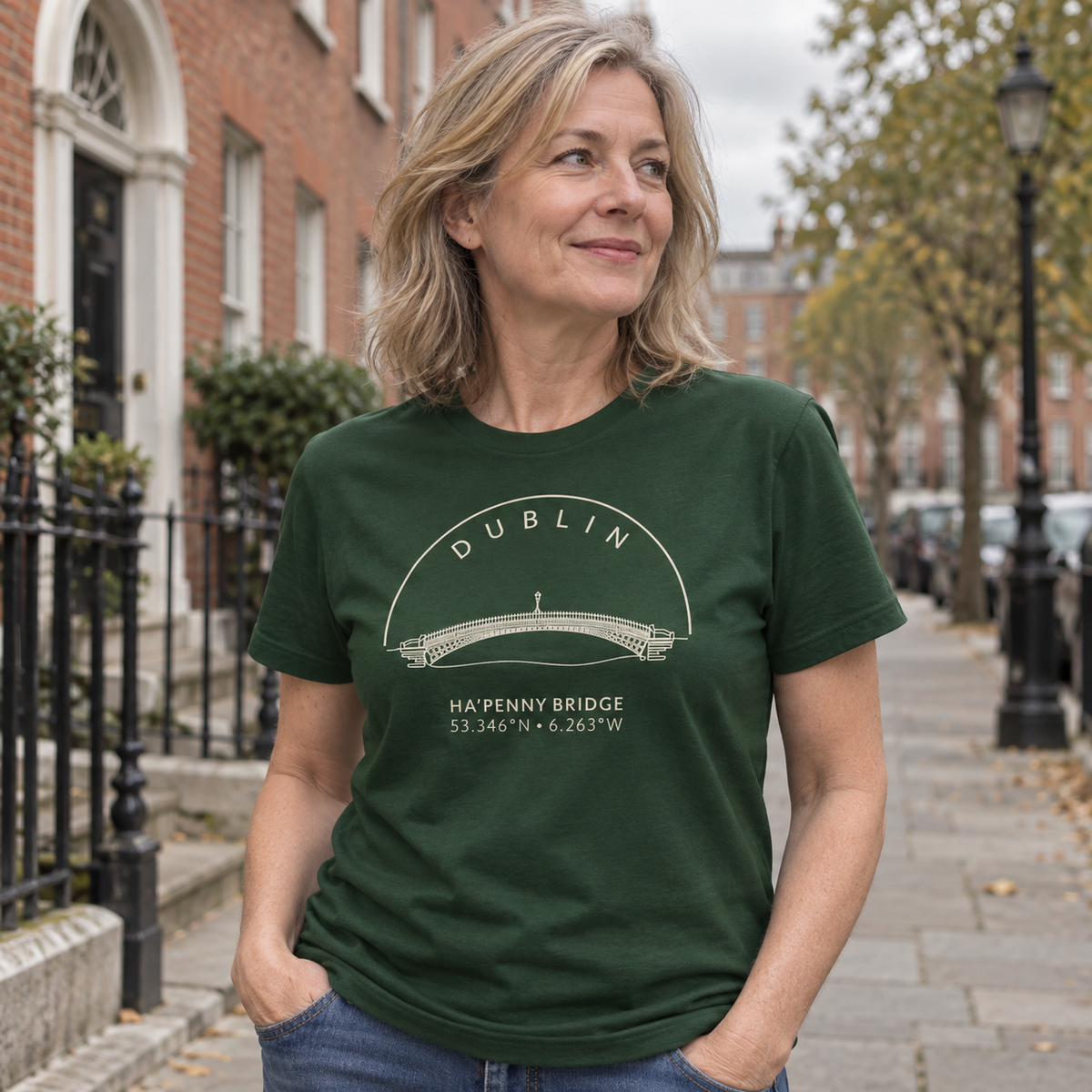 Woman wearing Dublin Ha’penny Bridge forest green T-shirt in a local setting