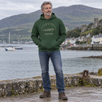 Man wearing the Louth Carlingford forest green hoodie at Carlingford harbour