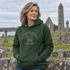 Woman wearing the Offaly Clonmacnoise forest green hoodie at Clonmacnoise