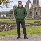 Man wearing the Roscommon Boyle Abbey forest green hoodie at Boyle Abbey