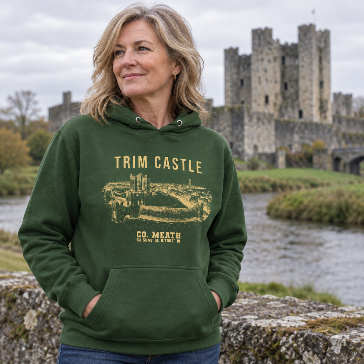 Woman wearing the Meath Trim Castle forest green hoodie at Trim Castle